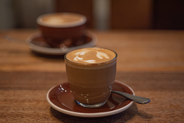 Wall Mural - Glass Cup of cortado coffee on table.