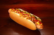 © Yuriy Afonkin - Danish hot dog with pickled cucumbers, fried onions, ketchup and mustard. On a wooden table.