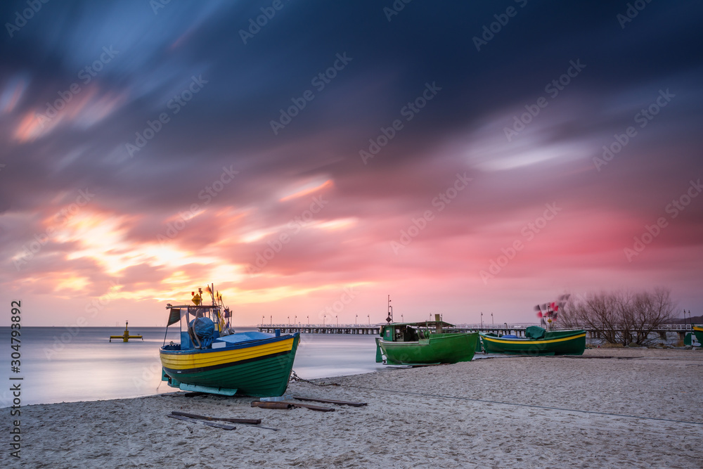 Fishing boats on the beach during sunrise in Gdynia. Baltic Sea. Poland - obrazy, fototapety, plakaty 