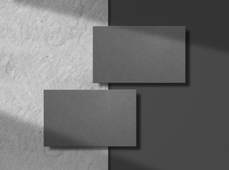 two black business cards on concrete background. mock up. template for corporate identity. empty obj