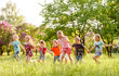 © Andrey - A group of happy children of boys and girls run in the Park on the grass on a Sunny summer day . The concept of ethnic friendship, peace, kindness, childhood