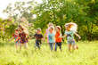 © Andrey - A group of happy children of boys and girls run in the Park on the grass on a Sunny summer day . The concept of ethnic friendship, peace, kindness, childhood