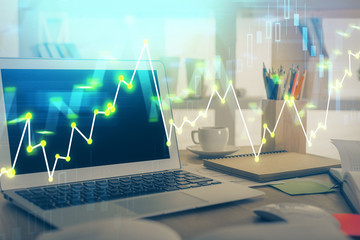 Forex market chart hologram and personal computer background. Double exposure. Concept of investment.