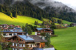 Traditional houses with solar panel roof in Austria . Tirol, Mountains, trees, grasses, and forest surrounding. Solar energy in Mountains.