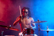 © alfa27 - portrait of professional drummer man vigorous and expressive, emotional playing on drum set isolated in studio