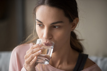 Close up of girl drinking water feeling thirsty