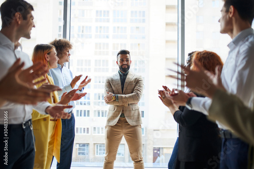 Happy business team clap their hands to co-worker for his great job, business people concept Tableau sur Toile