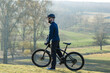 © Mountains Hunter - Cyclist in pants and fleece jacket on a modern carbon hardtail bike with an air suspension fork rides off-road.