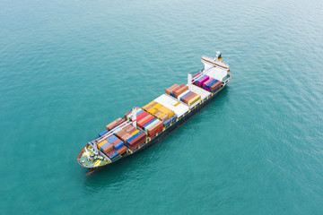 Stunning aerial view of a cargo ship sailing with hundreds of colored containers direct to the port of Singapore. The Port of Singapore is the second biggest port in the world.