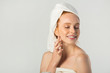 © Alexandr - beautiful young woman in a white towel with cream in her hands