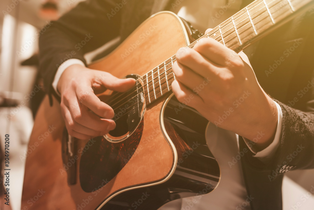 Acoustic guitar playing. A man playing an acoustic guitar. - obrazy, fototapety, plakaty 