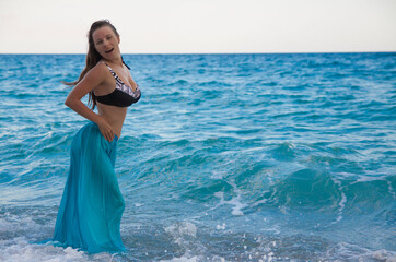 Wall Mural -   woman in bikini, blue skirt, sea