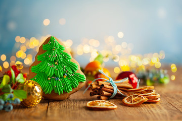 Wall Mural - Christmas gingerbread cookies with Christmas decorations on wooden background.