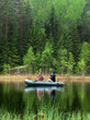 © Andrey - Two men catch fish from an inflatable boat with fishing rods on the lake in the summer