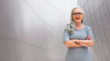 © elnariz - Wide banner panorama portrait of elder, senior, older CEO business woman standing confident, smiling, with arms folded, copy space