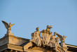  The statues of two eagles and a woman and a boy with a child on the top of a palace