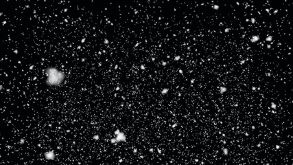 Snow flakes falling on black background. Winter weather