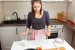 © yta - Cooking dough. Girl breaks chicken eggs in a bowl in the kitchen.