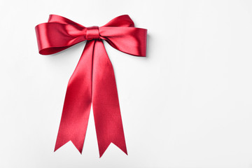 Bow made of red ribbon on white background