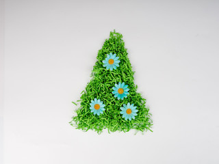 Canvas Print - green Christmas tree with flowers from shredded paper concept of economical use of resources, happy new year, recycling, separate garbage collection