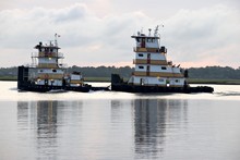 Tugboats Cruising On The River Just Before Sunset Florida, USA