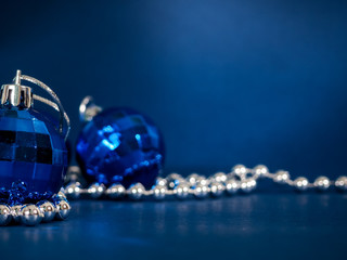 Canvas Print - Blue Christmas ball with silver beads. Bokeh effect on dark background. Copyspace for your greeting or wishes, banner