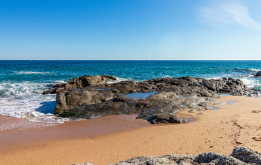 Wall Mural - On a beach in Lloret de Mar, water in peace and movement