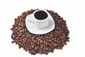 Wall Mural - white cup of coffee on a white saucer stands on a hill of coffee beans on a white background isolate, angle view from above