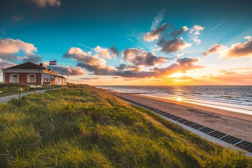 Poster - House on the grass covered beach by the ocean under the beautiful sky in Domburg, Netherlands