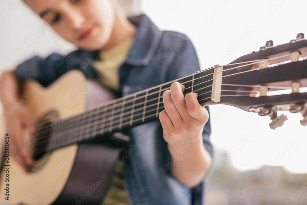 Blurred kid learning to play guitar - obrazy, fototapety, plakaty 