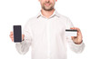 © Igor - cropped view of businessman holding smartphone with blank screen and credit card isolated on white