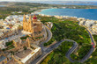 Aerial view of The Parish Church in Melieha city and road. Blue sky, sea, day. Winter. Malta island