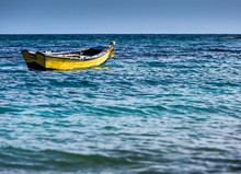 Small Yellow Fishing Boat On The Coast Of The Caribbean, In Dominican Republic.