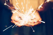 Close Up Hand Woman Holding Sparklers In Night Party And Christmas Celebration.