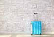 © Pixel-Shot - Suitcase near brick wall. Travel concept