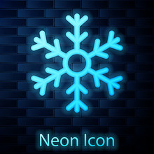 Glowing Neon Snowflake Icon Isolated On Brick Wall Background. Vector Illustration