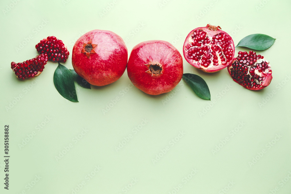 Ripe tasty pomegranates on color background