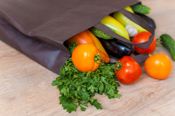 Poster -  Flat lay paper bag with various products on wooden background.