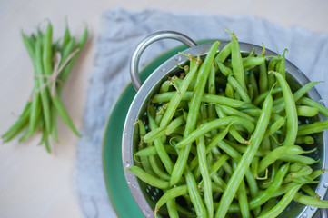 Wall Mural - Green beans washed in a rustic style. Selective focus.