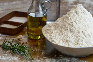 Wall Mural - ingredients for making Italian pizza dough at home. flour, salt, sugar, yeast, olive oil and water