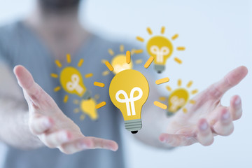  holding illuminated light bulb, idea, innovation and inspiration concept.