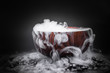 Smoke from dry ice in a wooden bowl, dark background
