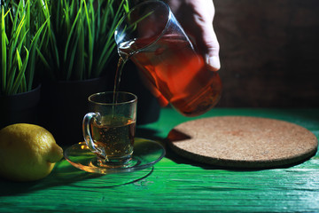 Wall Mural - Brewing tea on a wooden table