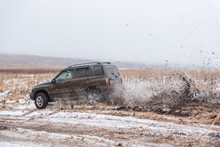 Off-road Driving. In A Jeep On The First Snow. Car In The Mud. Driving Through The Mud In A Simple Car.