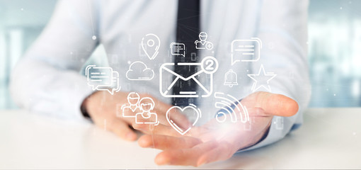 Businessman holding a cloud of social media network icon