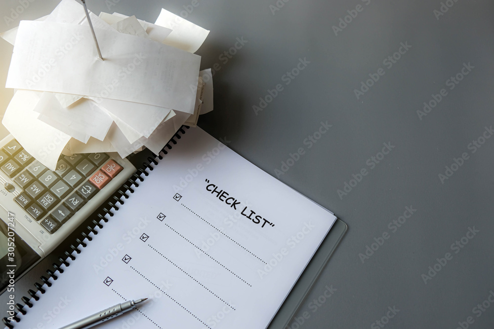 Checklist, pen near receipts payment or documents and calculator. It's ...