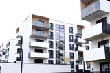 Fototapeta Sypialnia - Facade of a modern apartment buildings with balcony and white walls. No people.