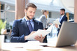 © ty - Portrait of young man sitting at his desk in the office.