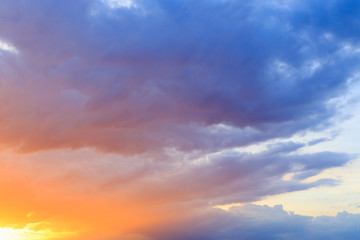 Wall Mural - Fantasy abstract background, Gold sunlight on colorful sky and moving purple blue cloud before sunset