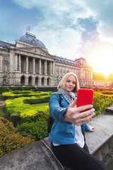 Wall Mural - Woman posing against the backdrop of the Royal Palace in Brussels, Belgium